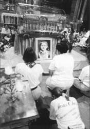 Youth at prayer before relic of St. Therese